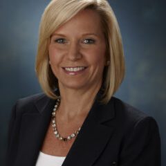 A headshot of Melissa Seymour, smiling, with shoulder-length blonde hair and a black blazer.